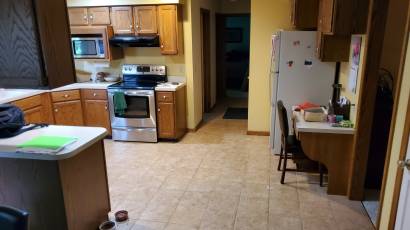 Before picture of a kitchen remodel with tile floors and wood cabinets